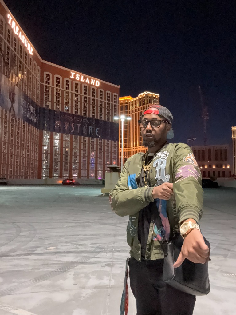 T Swerve standing in front of billboard at night