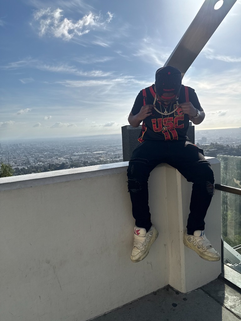 T Swerve sitting on balcony overlooking city skyline